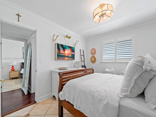 7945 SW 98th Ter, Miami, FL 33156 - bedroom featuring crown molding, light tile patterned flooring, a chandelier, and baseboards