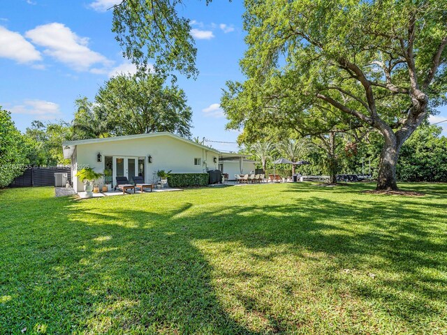 7945 SW 98th Ter, Miami, FL 33156 - view of yard featuring french doors, a patio area, and central AC