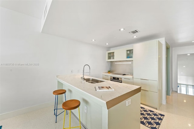 200 Biscayne Boulevard Way Unit 4005, Miami, FL 33131 - kitchen with a sink, stainless steel oven, a breakfast bar area, modern cabinets, and a peninsula