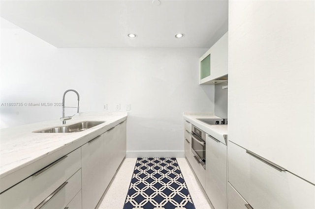 200 Biscayne Boulevard Way Unit 4005, Miami, FL 33131 - kitchen with a sink, black electric stovetop, stainless steel oven, white cabinetry, and recessed lighting