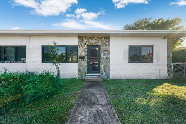 2 NW 47th St, Miami, FL 33127 - view of front facade featuring stone siding