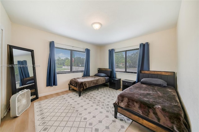 2 NW 47th St, Miami, FL 33127 - bedroom featuring multiple windows and light wood-style flooring
