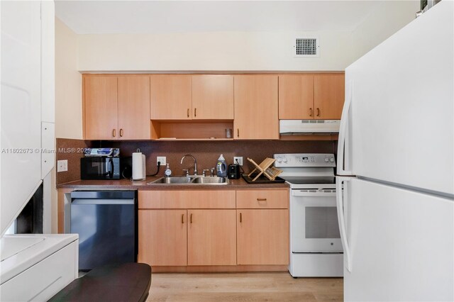 2 NW 47th St, Miami, FL 33127 - kitchen featuring white appliances, light brown cabinets, tasteful backsplash, light wood finished floors, and under cabinet range hood