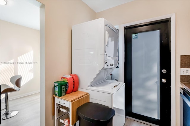 2 NW 47th St, Miami, FL 33127 - laundry room with stacked washer and clothes dryer, light wood-style floors, and baseboards