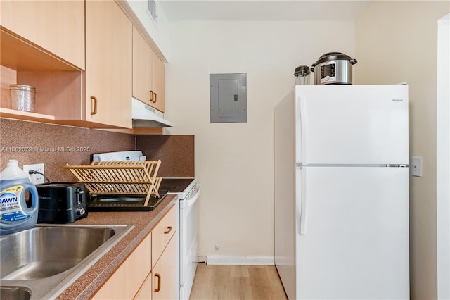 2 NW 47th St, Miami, FL 33127 - kitchen featuring white appliances, light wood-style flooring, light brown cabinets, electric panel, and under cabinet range hood