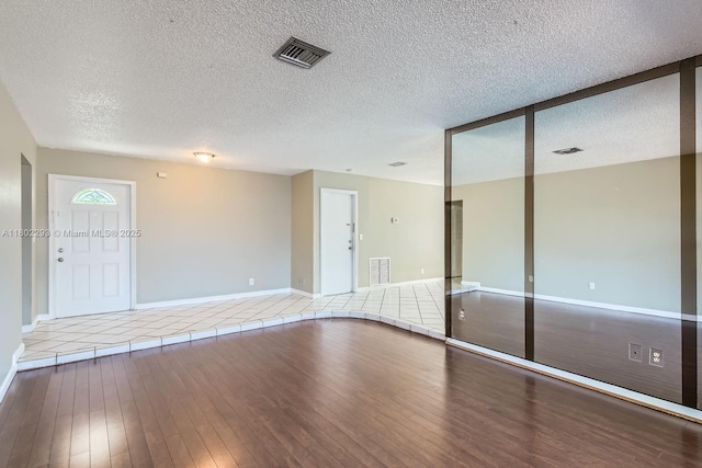 10950 NW 38th Ct, Coral Springs, FL 33065 - entrance foyer with hardwood / wood-style flooring, baseboards, and a textured ceiling