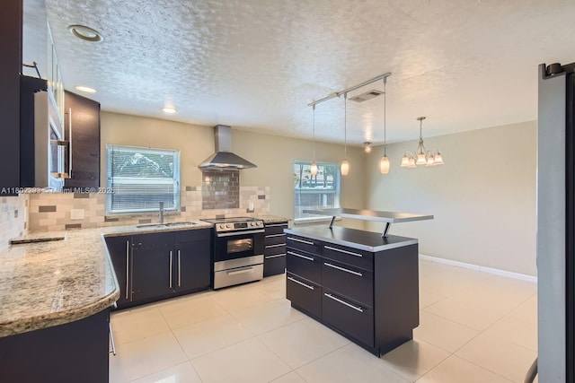 10950 NW 38th Ct, Coral Springs, FL 33065 - kitchen featuring stainless steel range with electric cooktop, wall chimney range hood, a sink, plenty of natural light, and a textured ceiling