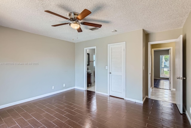 10950 NW 38th Ct, Coral Springs, FL 33065 - unfurnished bedroom with baseboards, a textured ceiling, ceiling fan, a closet, and dark wood-type flooring