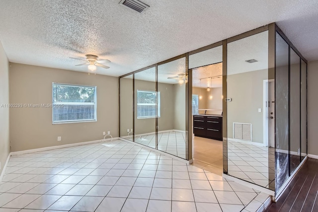 10950 NW 38th Ct, Coral Springs, FL 33065 - unfurnished bedroom with a textured ceiling, baseboards, and light tile patterned flooring