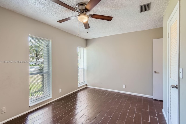 10950 NW 38th Ct, Coral Springs, FL 33065 - spare room with a textured ceiling, plenty of natural light, ceiling fan, dark wood-type flooring, and baseboards