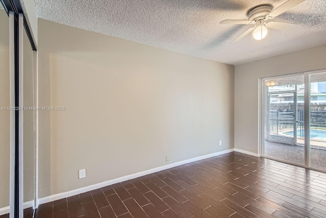 10950 NW 38th Ct, Coral Springs, FL 33065 - spare room with a textured ceiling, a ceiling fan, baseboards, and dark wood-style flooring