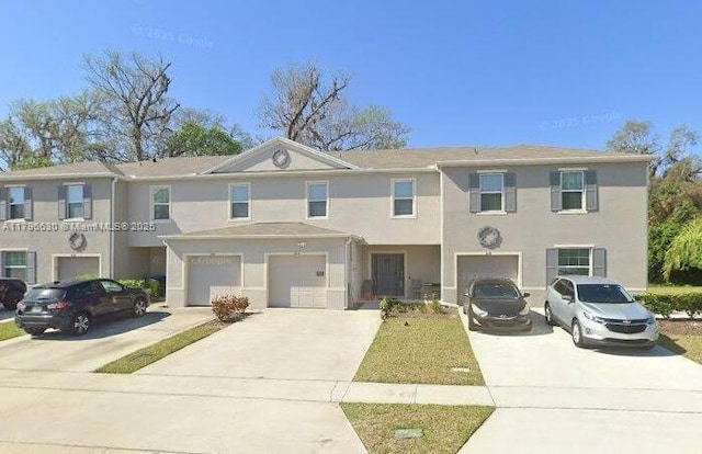 1612 Primo Ct, Daytona Beach, FL 32117 - view of property with driveway, a garage, and stucco siding