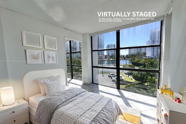 1000 Parkview Dr Unit 424, Hallandale Beach, FL 33009 - bedroom featuring light tile patterned floors, a water view, and a city view
