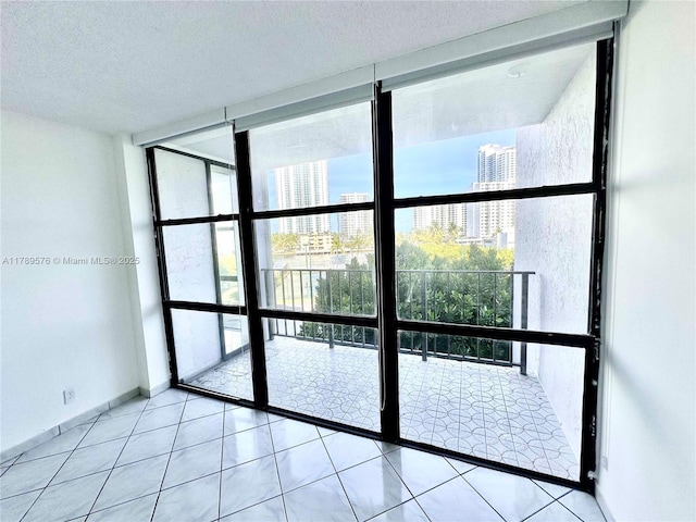 1000 Parkview Dr Unit 424, Hallandale Beach, FL 33009 - spare room featuring floor to ceiling windows, healthy amount of natural light, a view of city, tile patterned floors, and a textured ceiling
