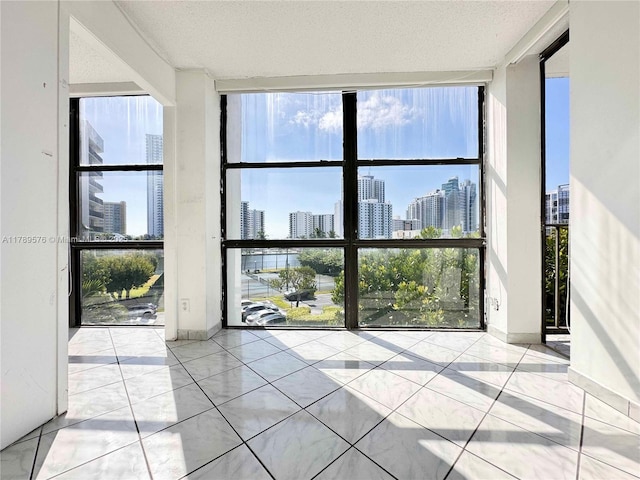 1000 Parkview Dr Unit 424, Hallandale Beach, FL 33009 - unfurnished room with expansive windows, a skyline view, and a textured ceiling