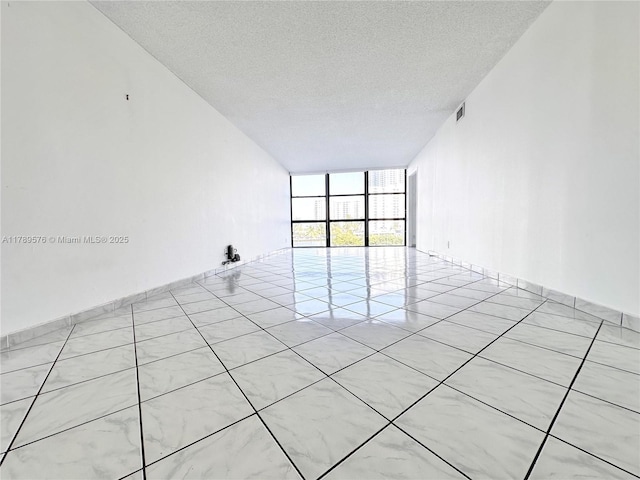 1000 Parkview Dr Unit 424, Hallandale Beach, FL 33009 - unfurnished room with a wall of windows and a textured ceiling