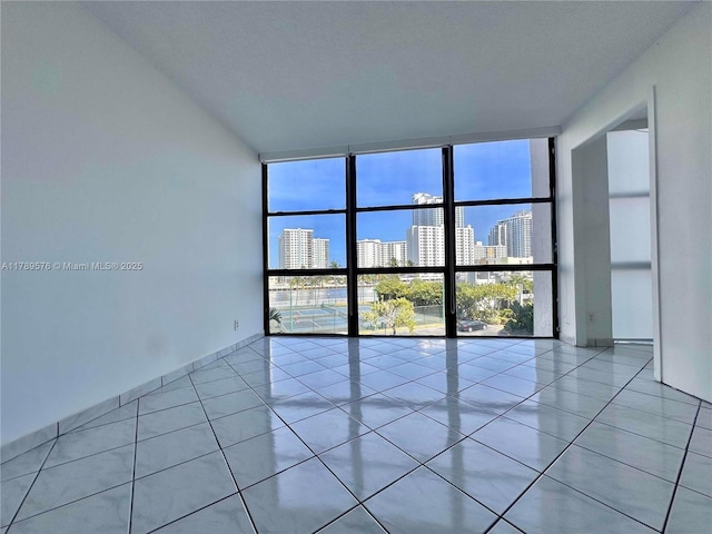 1000 Parkview Dr Unit 424, Hallandale Beach, FL 33009 - unfurnished room with a wall of windows, a skyline view, and light tile patterned floors