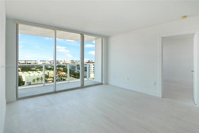 650 W Ave Unit 1404, Miami Beach, FL 33139 - unfurnished room featuring a view of city and a wall of windows