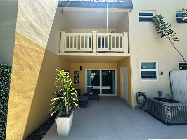 8443 SW 137th Ave Unit 8443, Miami, FL 33183 - back of house with a balcony, stucco siding, central AC unit, and a patio