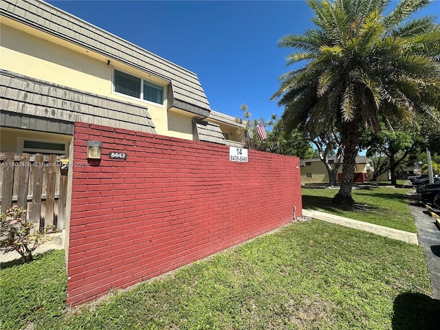 8443 SW 137th Ave Unit 8443, Miami, FL 33183 - view of side of property featuring mansard roof and stucco siding