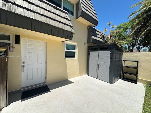 8443 SW 137th Ave Unit 8443, Miami, FL 33183 - doorway to property with stucco siding, mansard roof, and a patio area