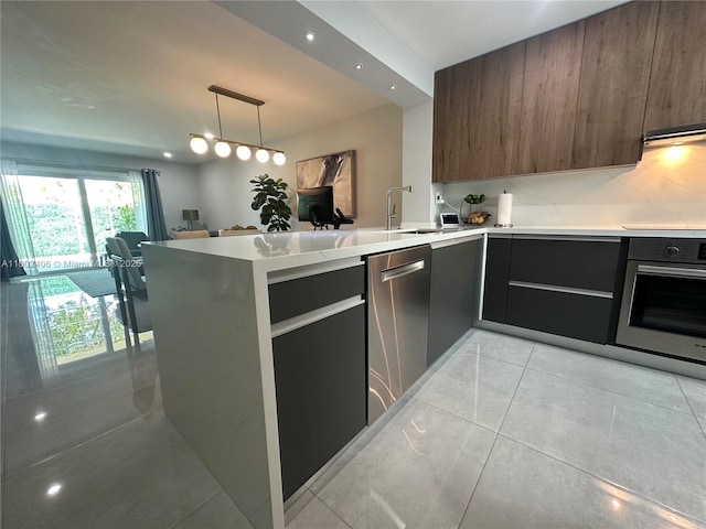 8443 SW 137th Ave Unit 8443, Miami, FL 33183 - kitchen featuring appliances with stainless steel finishes, modern cabinets, light countertops, a peninsula, and recessed lighting