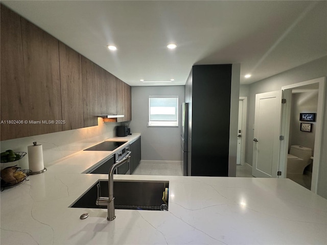 8443 SW 137th Ave Unit 8443, Miami, FL 33183 - kitchen with stainless steel appliances, light stone counters, modern cabinets, recessed lighting, and baseboards