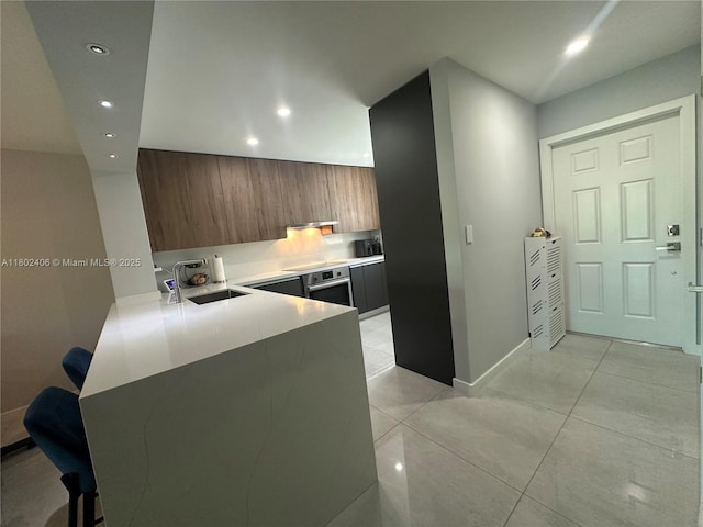 8443 SW 137th Ave Unit 8443, Miami, FL 33183 - kitchen featuring stainless steel oven, a sink, recessed lighting, modern cabinets, and a peninsula