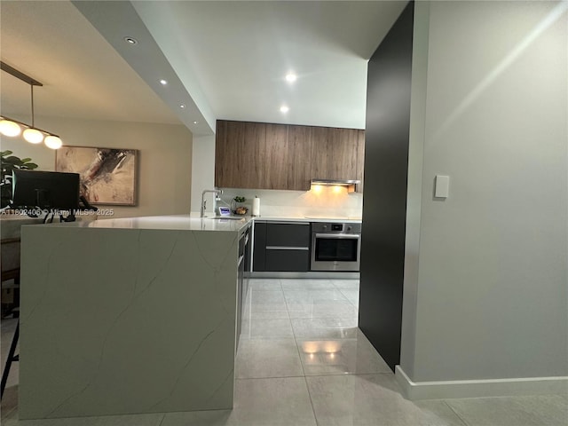 8443 SW 137th Ave Unit 8443, Miami, FL 33183 - kitchen featuring stainless steel oven, modern cabinets, recessed lighting, light countertops, and a peninsula