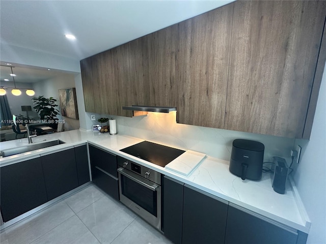 8443 SW 137th Ave Unit 8443, Miami, FL 33183 - kitchen featuring stainless steel oven, modern cabinets, black electric cooktop, a sink, and light tile patterned floors