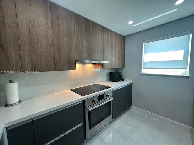 8443 SW 137th Ave Unit 8443, Miami, FL 33183 - kitchen with stainless steel oven, black electric stovetop, modern cabinets, light countertops, and light tile patterned floors