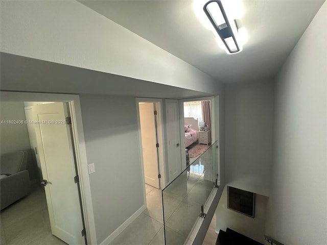 8443 SW 137th Ave Unit 8443, Miami, FL 33183 - hallway featuring light tile patterned floors, vaulted ceiling, and baseboards