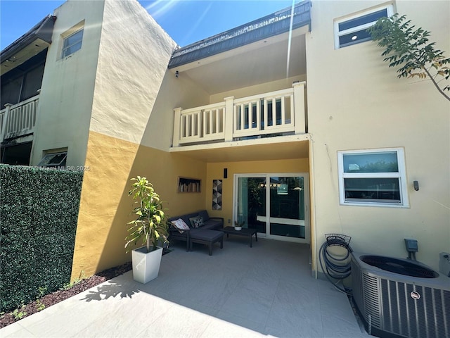8443 SW 137th Ave Unit 8443, Miami, FL 33183 - back of property with a balcony, an outdoor hangout area, stucco siding, central AC, and a patio area