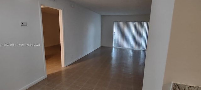 corridor featuring baseboards