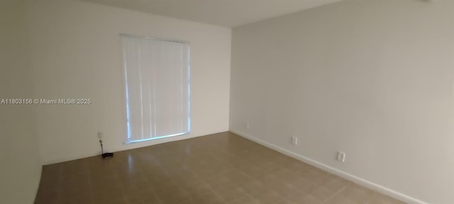 empty room featuring baseboards