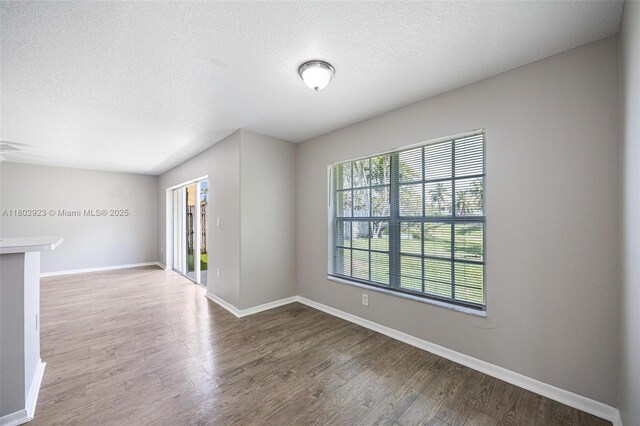 16421 SW 103rd Ter, Miami, FL 33196 - spare room featuring baseboards, wood finished floors, and a textured ceiling