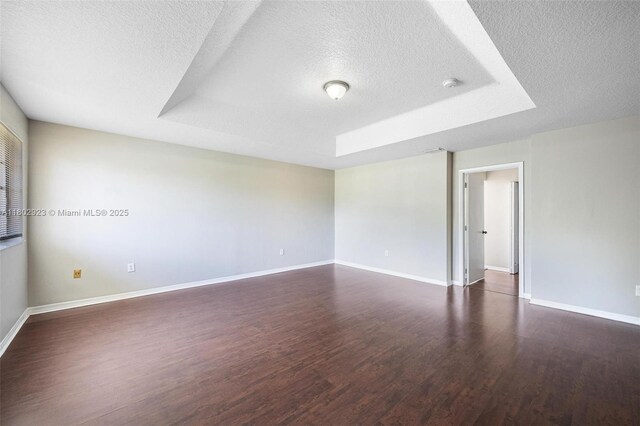 16421 SW 103rd Ter, Miami, FL 33196 - unfurnished room with a textured ceiling, dark wood-style floors, baseboards, and a smoke detector