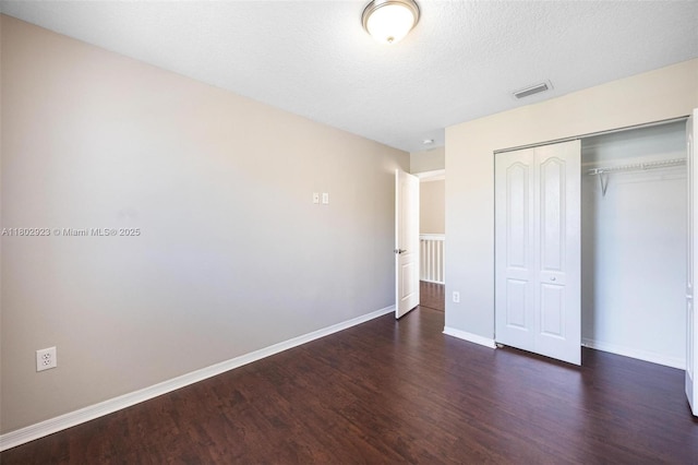 16421 SW 103rd Ter, Miami, FL 33196 - unfurnished bedroom with wood finished floors, a closet, baseboards, and a textured ceiling