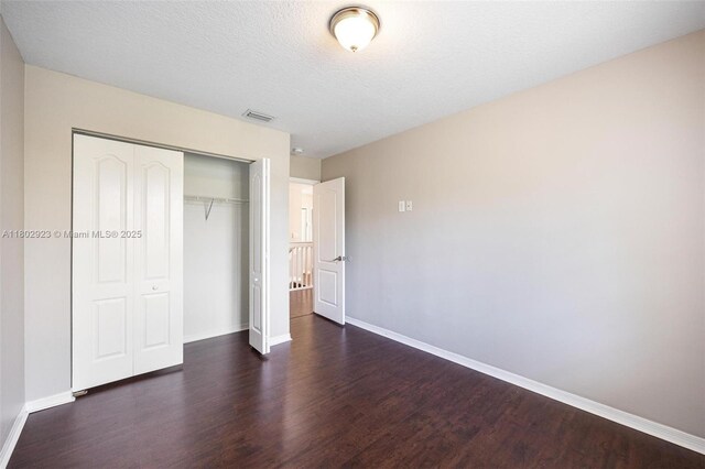 16421 SW 103rd Ter, Miami, FL 33196 - unfurnished bedroom featuring wood finished floors, baseboards, and a closet