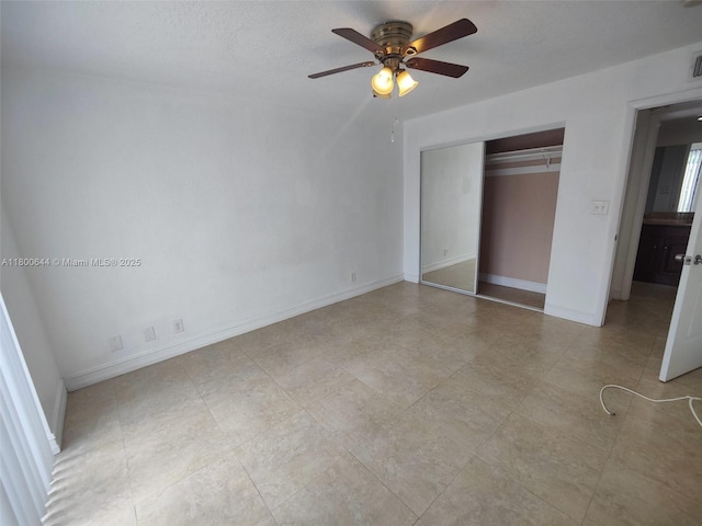 616 Executive Center Dr Unit 107, West Palm Beach, FL 33401 - unfurnished bedroom with a closet, baseboards, and a ceiling fan