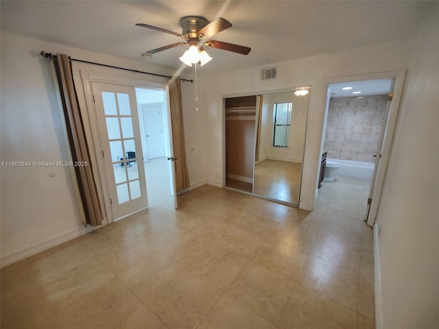 616 Executive Center Dr Unit 107, West Palm Beach, FL 33401 - unfurnished bedroom with a closet, ceiling fan, light tile patterned floors, and baseboards