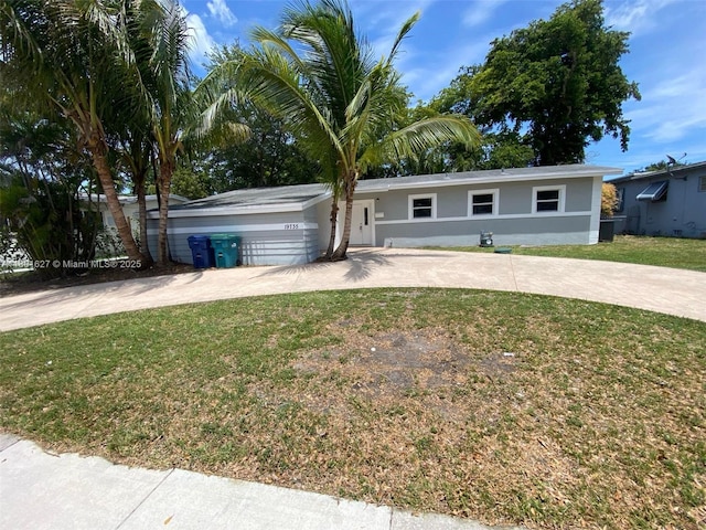 19735 NE 12th Ave, Miami, FL 33179 - ranch-style house featuring concrete driveway, a front yard, and stucco siding