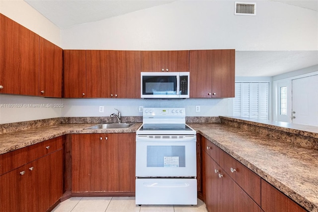 19735 NE 12th Ave, Miami, FL 33179 - kitchen with stainless steel microwave, a sink, white range with electric cooktop, lofted ceiling, and brown cabinetry
