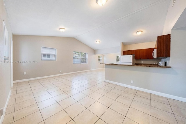 19735 NE 12th Ave, Miami, FL 33179 - kitchen with white appliances, vaulted ceiling, dark countertops, a peninsula, and open floor plan