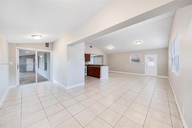19735 NE 12th Ave, Miami, FL 33179 - unfurnished living room with light tile patterned floors, vaulted ceiling, and baseboards