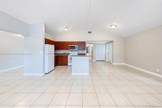 19735 NE 12th Ave, Miami, FL 33179 - kitchen featuring white appliances, vaulted ceiling, baseboards, open floor plan, and light tile patterned floors