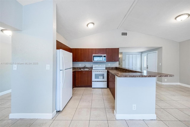 19735 NE 12th Ave, Miami, FL 33179 - kitchen featuring white appliances, a peninsula, light tile patterned flooring, dark countertops, and lofted ceiling