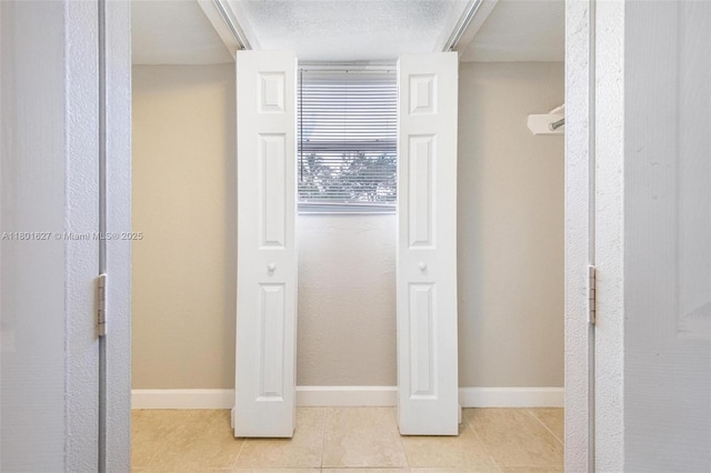 19735 NE 12th Ave, Miami, FL 33179 - hallway with tile patterned floors and baseboards