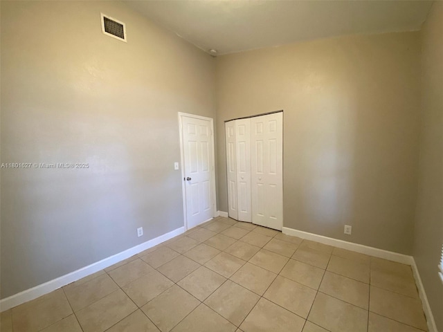 19735 NE 12th Ave, Miami, FL 33179 - unfurnished bedroom with light tile patterned floors, baseboards, and a closet