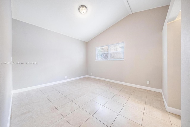 19735 NE 12th Ave, Miami, FL 33179 - empty room with light tile patterned floors, vaulted ceiling, and baseboards